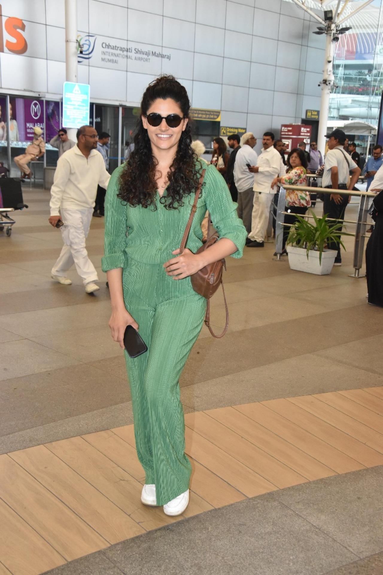 Actress Saiyami Kher returned to Mumbai in style on Monday. She wore a light green dress and white sneakers to complete her elegant appearance. She also carried a brown purse